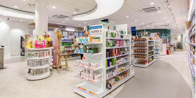 Photo qui montre l'intérieur d'une pharmacie avec le mobilier et comptoirs design