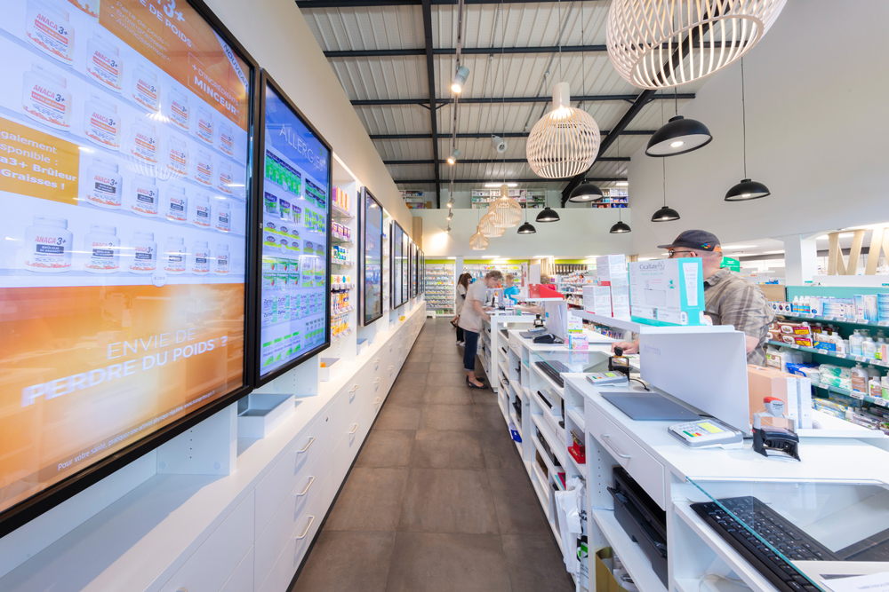 Comptoirs lumineux et fonctionnels intégrant des écrans digitaux pour une expérience client connectée.