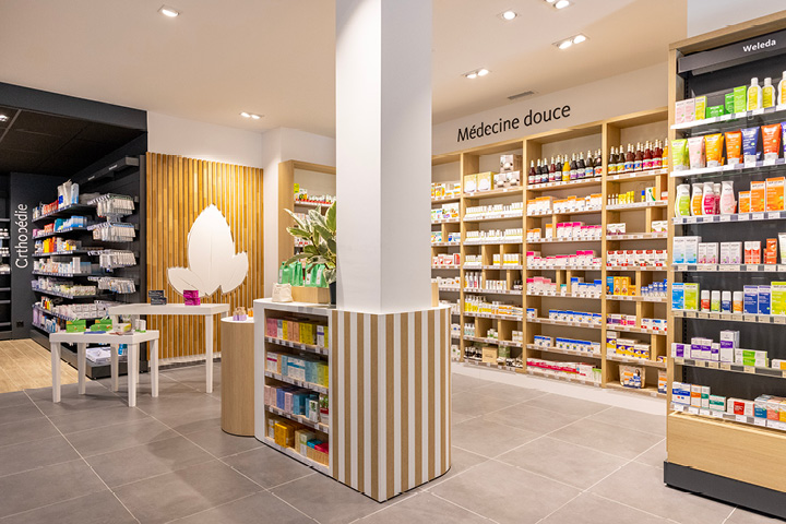 Vue générale de l’espace de vente lumineux et spacieux de la Pharmacie Populaire, avec parcours client optimisé.