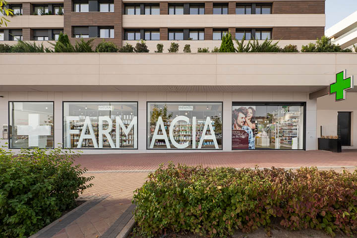 Façade moderne et lumineuse de la Pharmacie Valdecarrizo à Tres Cantos, Madrid, avec signalétique claire et vitres transparentes, reflétant l’identité visuelle de l’officine.