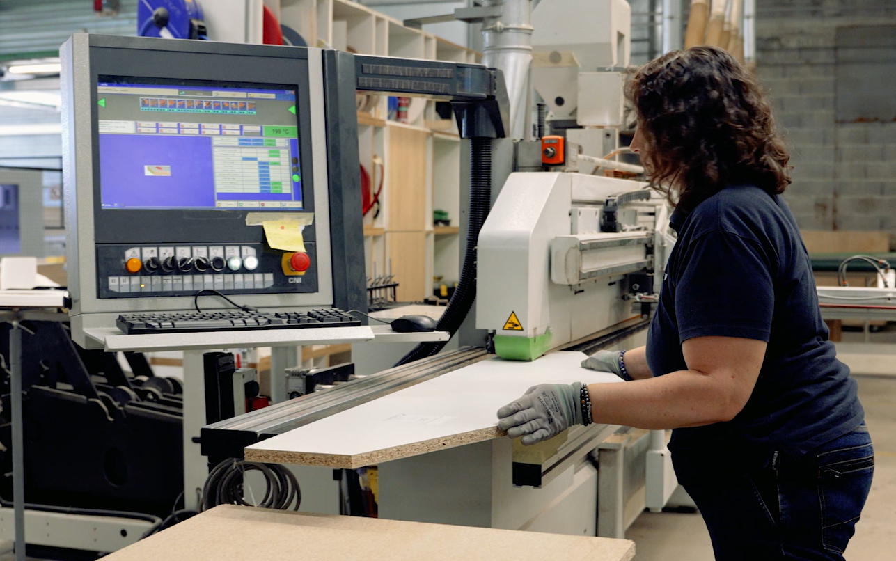 Menuisière qualifiée au travail dans l'atelier de fabrication Mobil M Agencement.